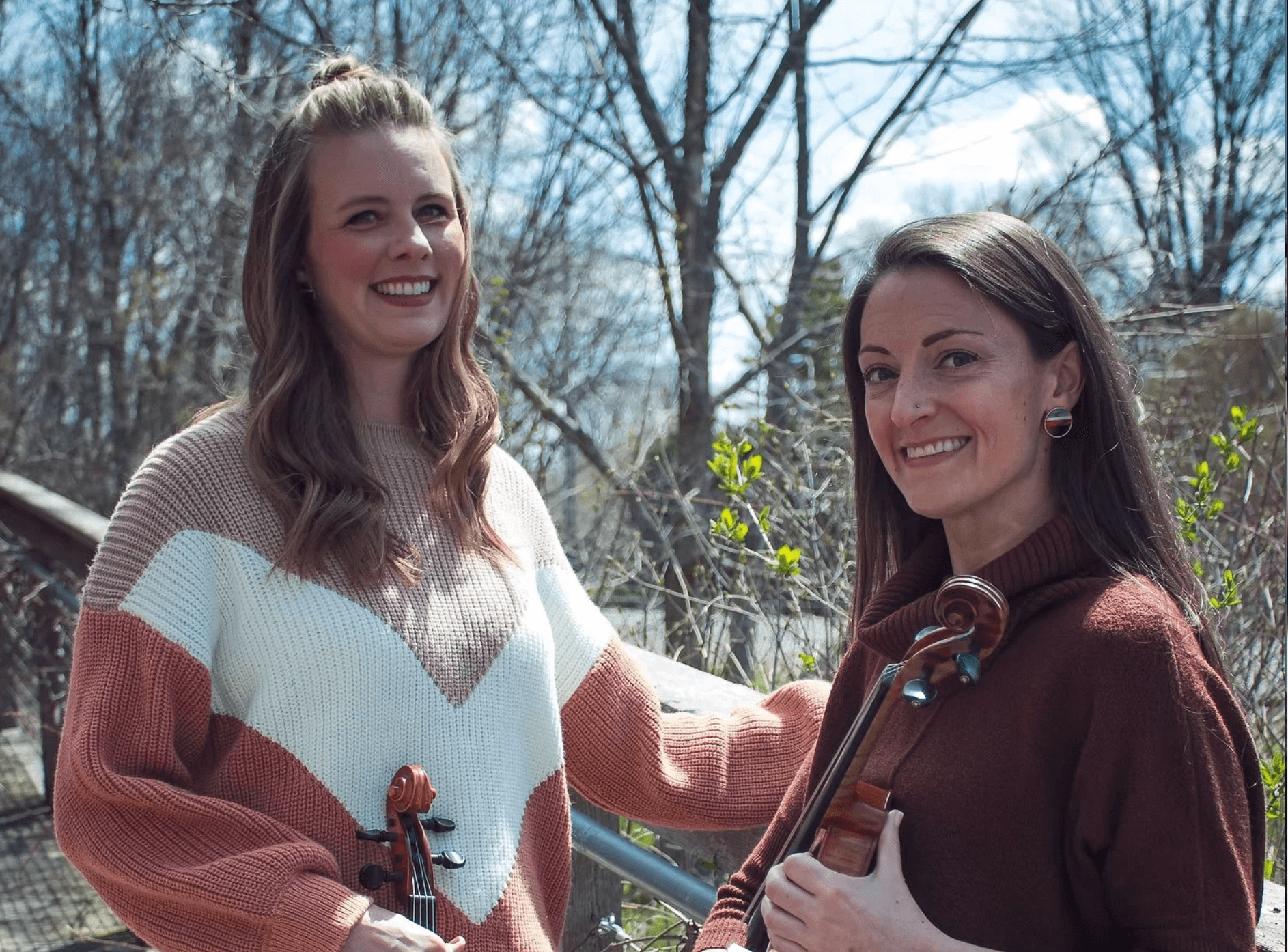 Jessica and Janet, hosts of Teaching Orchestra Pod, holding their violins